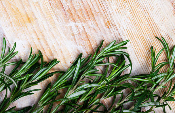 Image of green rosemary on wooden background, top view - Foto, imagen