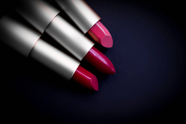 Lipstick on a dark background, cosmetics product - Valokuva, kuva