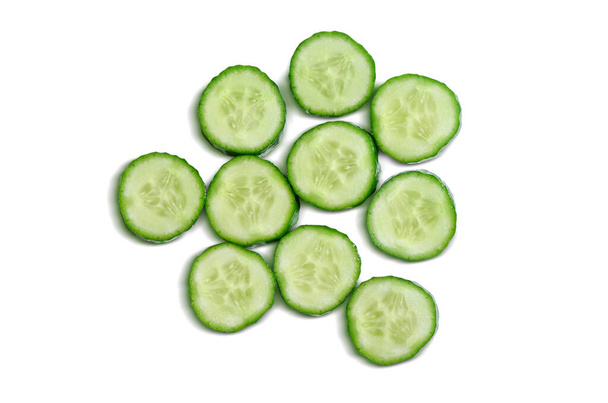 Top view of cucumber slices isolated on a white background. Includes a clipping path around the cucumber slices. - Foto, Bild