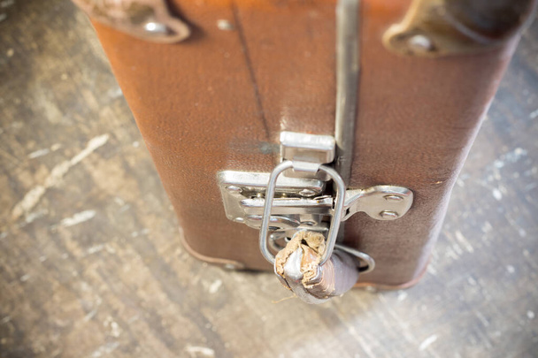 Old brown suitcase with metal locks close up - Foto, imagen