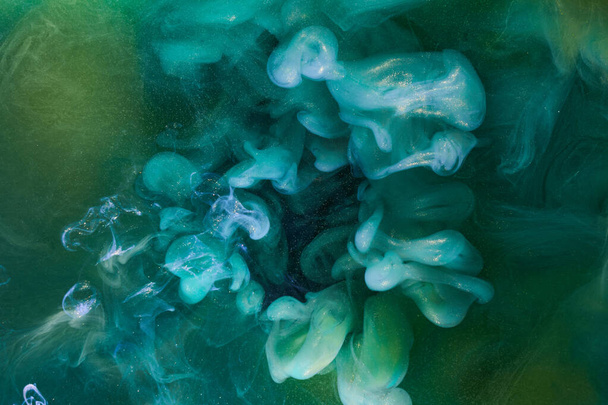 Liquid fluid art abstract background. Green dancing acrylic paints underwater, cosmic smoke ocean - Photo, Image