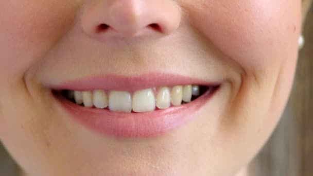 Closeup of a woman smiling and laughing with joy. Zoom in on mouth, lips and teeth of a cheerful and confident female feeling positive in a happy mood. Good oral hygiene leads to a beautiful smile. - Filmati, video