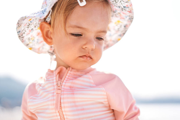 Little girl in a panama hat looks down. Portrait. High quality photo - Foto, Imagen