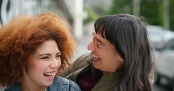 Portrait of happy friends hugging and kissing outside in the city. Diverse females embracing each other, spending the day together in the city, enjoying a fun time celebrating the end of a pandemic. - Video