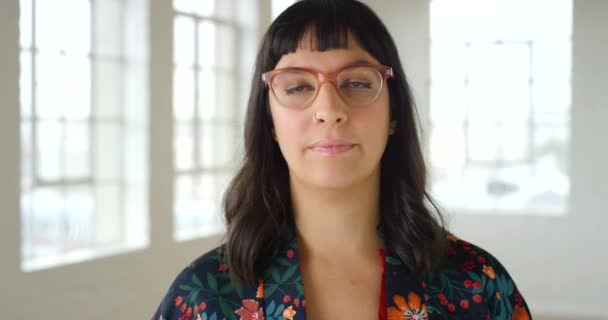 Trying on new prescription glasses for improved vision and eyesight. Closeup portrait of the face and head of a woman at the optometrist for a checkup and a brand new pair of spectacles. - Materiał filmowy, wideo