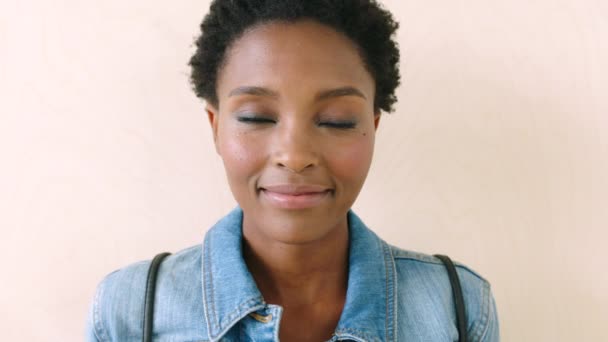 Trendy young african woman smiling and laughing with joy at the camera. Portrait of a cheerful, cool and confident black female student feeling motivated with a positive attitude and good mood. - Záběry, video