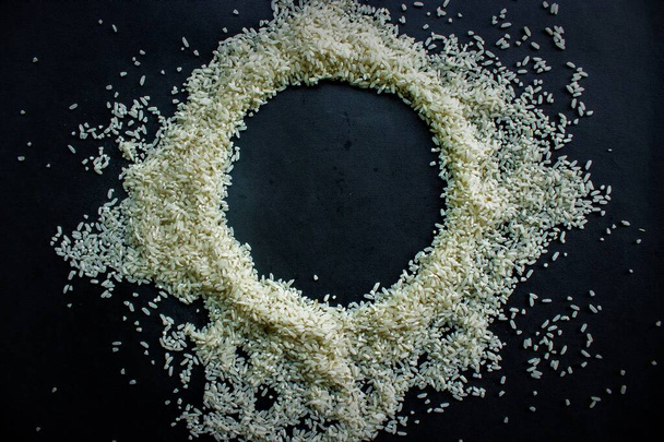 Raw rice from Indonesia with look circle shape in the center isolated on black background - Photo, image