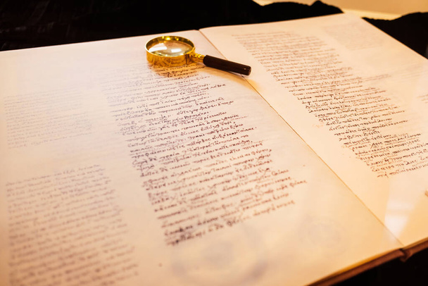 Replica of a book with ancient Greek writings on paper. - 写真・画像