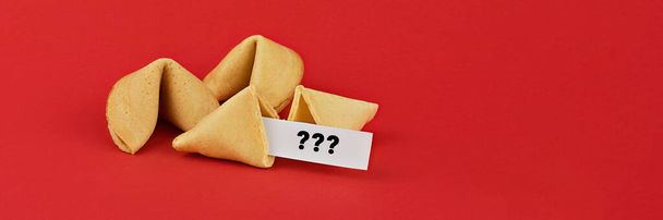 Chinese fortune cookies on red background with question marks note. Abstract Unknown future of World concept - Foto, imagen