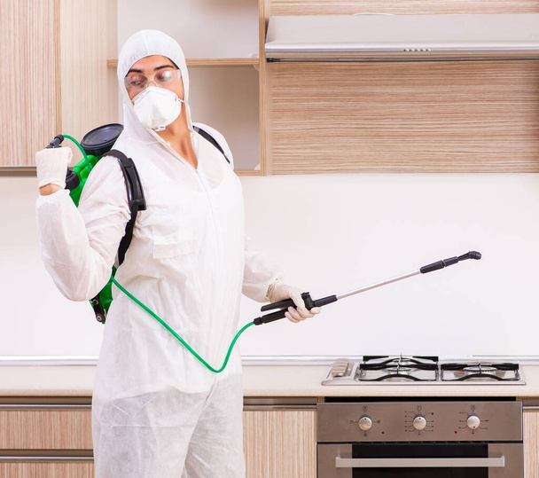 The professional contractor doing pest control at kitchen - Photo, Image