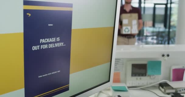 4k video footage of a young man delivering a package to a modern office. - Felvétel, videó