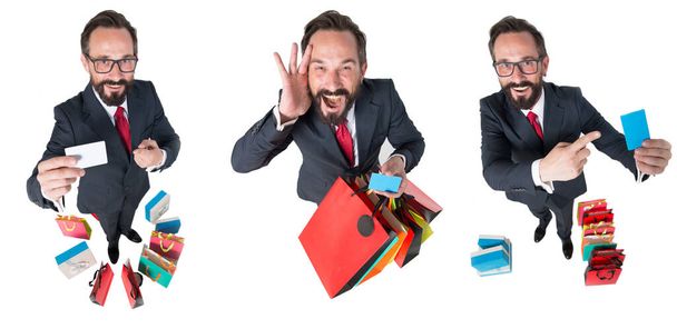 Collage of emotions of attractive businessman with shopping bags and credit card in hands. Shocked man of sales proposal isolated on white background. An amazed bearded man is extremely happy about sales and purchases. Horizontal shot of expressions  - Fotoğraf, Görsel