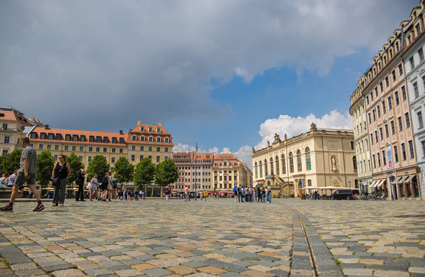 Dresden, Germany - June 28, 2022: The Neumarkt in the old town of Dresden. Low angle view over the square paved with cobblestones,  towards the Transport Museum (Verkehrsmuseum). Tourist on the street - 写真・画像