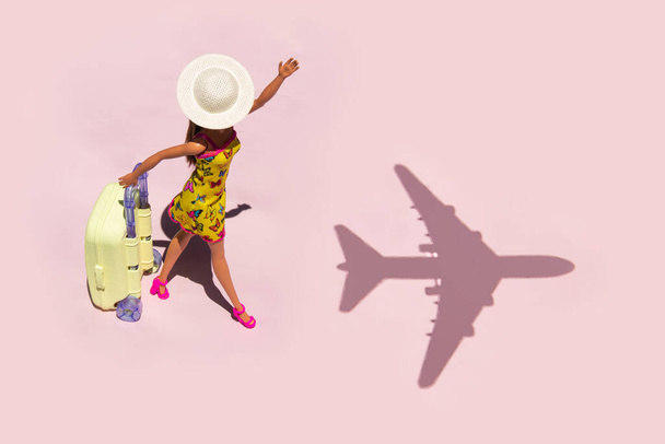 Creative lost chances concept. Minimal travel composition. Late for airplane on pastel light pink background. - Fotó, kép