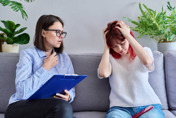 Professional psychologist working with teenage student girl. Female patient stressed out, individual therapy, help to teenager. Mental health, counseling, adolescence, psychology, psychiatry concept - Foto, imagen