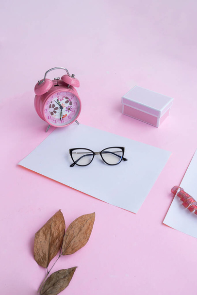 Fashion and beauty concept lying flat with square glasses, women's accessories on pink background. - Zdjęcie, obraz
