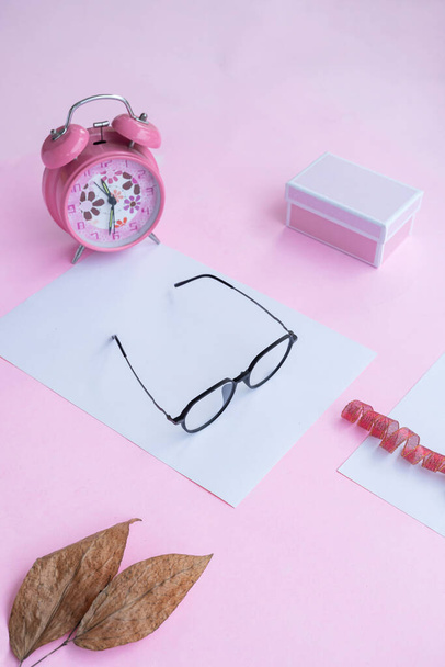 Fashion and beauty concept lying flat with square glasses, women's accessories on pink background. - Zdjęcie, obraz