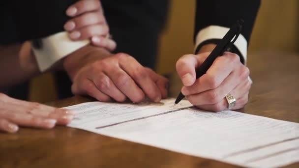 Bride and groom signing a document during a wedding. - Materiał filmowy, wideo