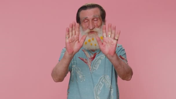 No stop. Serious man say no, hold palm folded crossed hands in stop danger gesture, warning of finish, prohibited access, declining communication, body language. Senior grandfather on pink background - Filmati, video