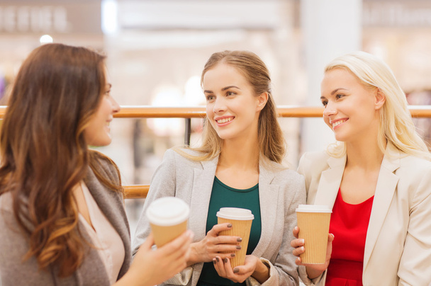 young women with shopping bags and coffee in mall - Foto, Imagem