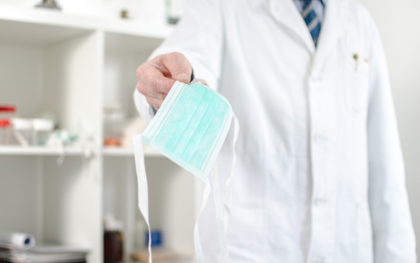 Doctor holding a surgical mask - Photo, Image
