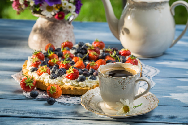 Coffee and fruit tarts served in the garden - Photo, Image