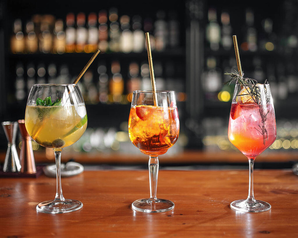 Three assorted refreshing fruit cocktails on the bar counter - Photo, Image