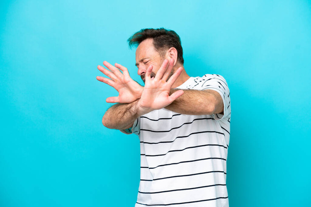 Middle age caucasian man isolated on blue background nervous stretching hands to the front - Φωτογραφία, εικόνα