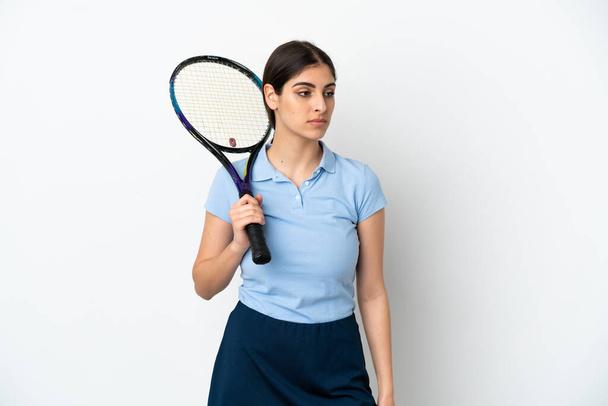 Handsome young tennis player caucasian woman isolated on white background looking to the side - Photo, Image