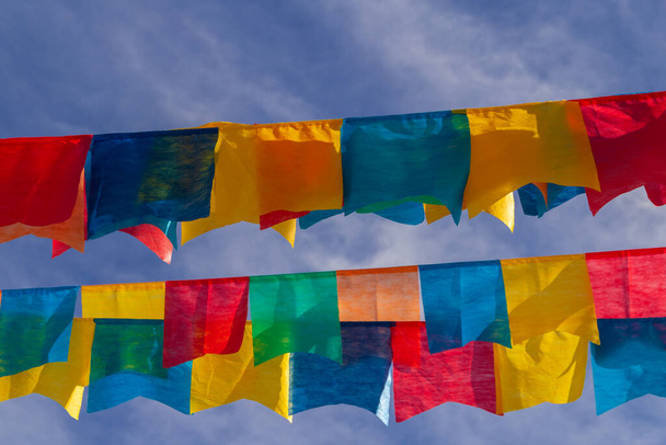 Algunos tendederos con banderines de tela contra el cielo azul para la fiesta de junio, típica fiesta brasileña. Quadrilha.June celebración. - Foto, Imagen