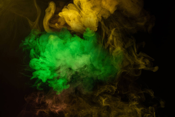 Yellow and pink steam on a black background. Copy space. - Fotoğraf, Görsel