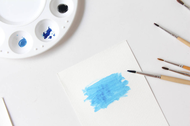 Water-colouring supplies on the table, paper, palette and brushes. - 写真・画像