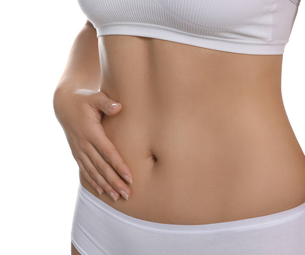 Woman in underwear touching her belly on white background, closeup. Healthy stomach - Fotó, kép