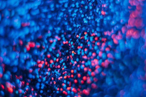 Blur neon glitter. Bokeh light flare. Sci-Fi illumination. Defocused navy blue red color circles texture glow futuristic abstract background. - Foto, afbeelding