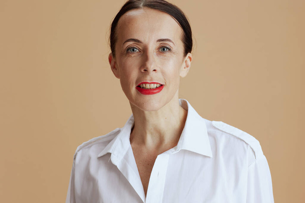 modern female in white shirt against beige background. - Фото, зображення