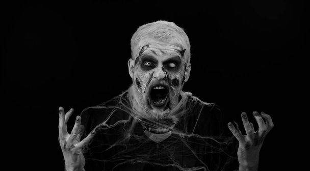 Niezadowolony agresywny mężczyzna z krwawym zombie Halloween zraniony makijaż prosząc o przyczynę porażki, wyrażając niedowierzanie irytacja, uczucie znudzenia, rozczarowany w rezultacie, złe wieści. Złowrogi nieumarły facet. - Zdjęcie, obraz