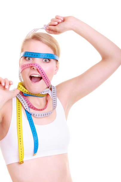 Woman with a lot of colorful measure tapes - Photo, Image