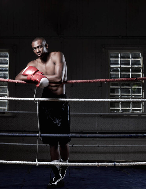 Full length of handsome African American male boxer standing near ring. - 写真・画像