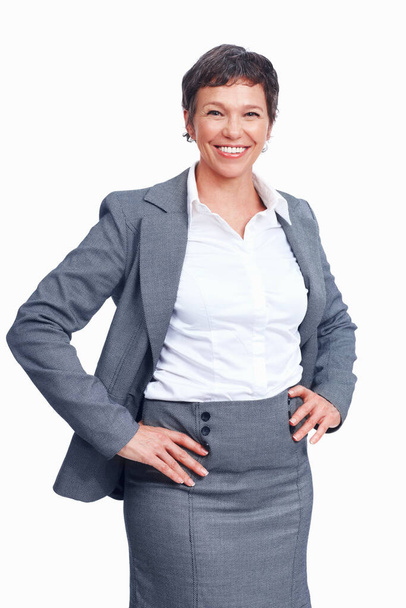 Confident female executive smiling over white background with hands on waist. - Foto, immagini