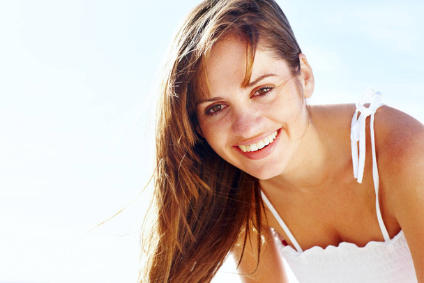 Closeup portrait of a happy young female smiling against sky. - Fotografie, Obrázek