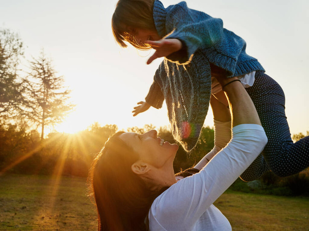 a mother and daughter enjoying some time outdoors together. - 写真・画像