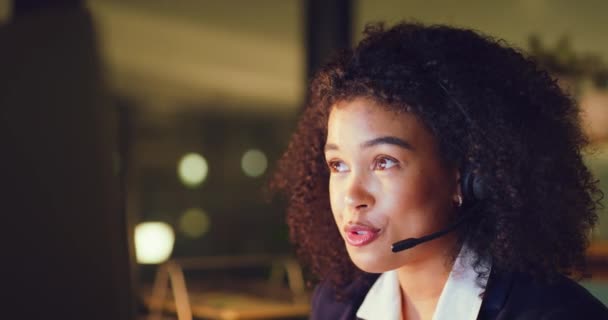 Young female center agent talking and giving advice to customers while working late in an office alone. One black female helpline worker having a conversation with a client and doing overtime. - Séquence, vidéo