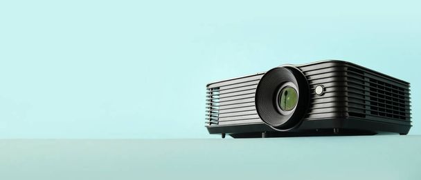Video projector on light blue background with space for text - Foto, Bild
