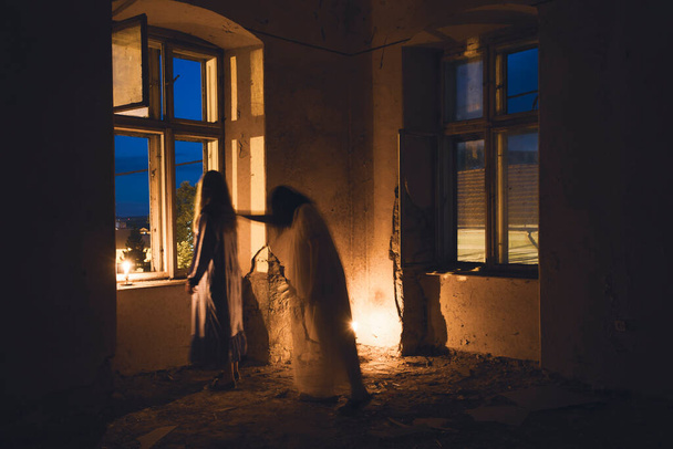 Ghosts in abandoned, haunted house. Horror scene of scary spirits, halloween concept. - Фото, зображення
