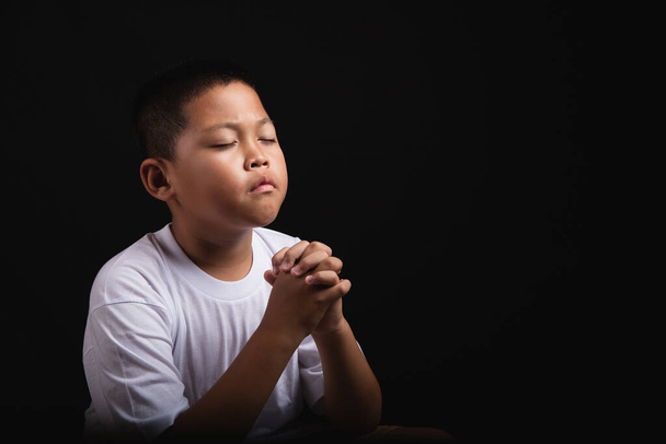 Boy praying to God at home, World Day of Prayer, international day of prayer, hope, gratitude, thankful, trust - Foto, immagini