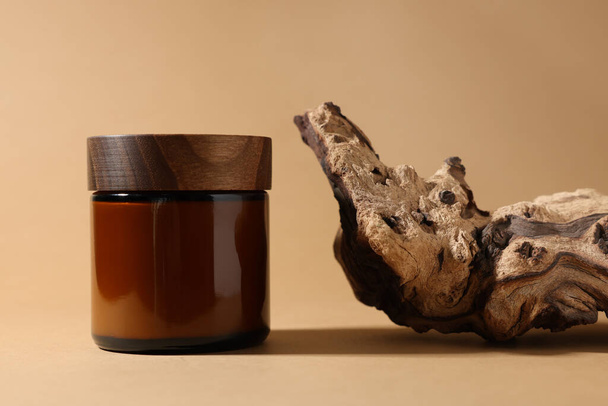 Jar of luxury cream and tree bark on dark beige background - Foto, immagini