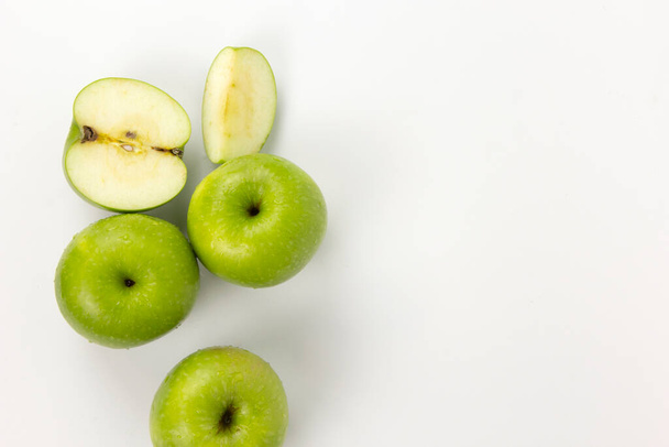 Groups of green apple with cut in half slices isolated on white background, organic fruits for health, a set of apples on top view - Valokuva, kuva