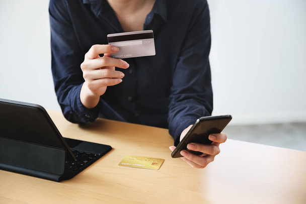 Онлайн-оплата, Молодые Женщины вручают кредитную карту и используют смартфон для онлайн-покупок. - Фото, изображение