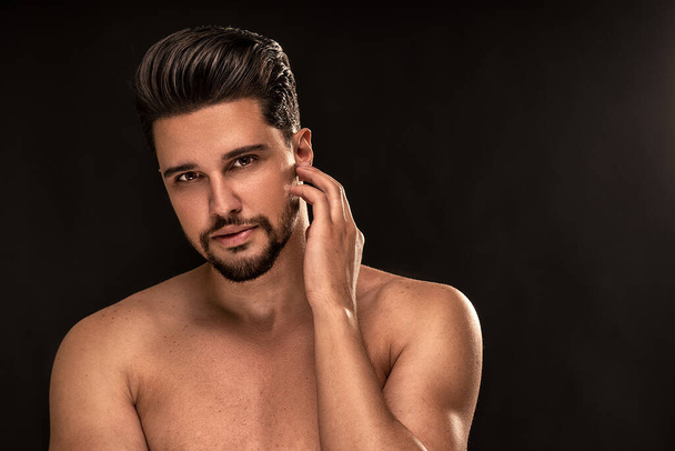 Beauty portrait of handsome, sexy male model with beard looking at the camera. Shirtless man posing on the black studio background. - Valokuva, kuva
