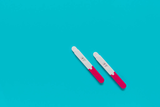 positive and negative pregnancy tests on blue background - Photo, Image